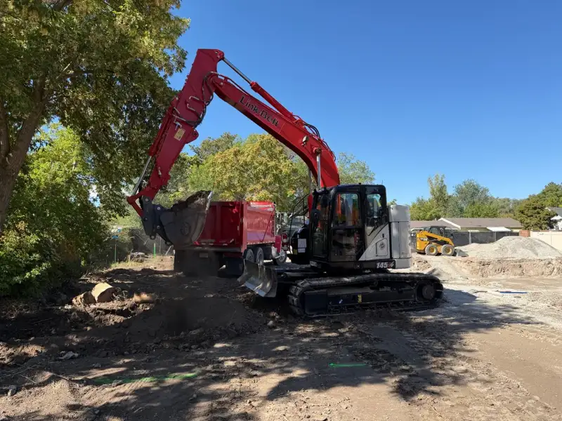 JNB excavator loading its dump truck at a Utah job site